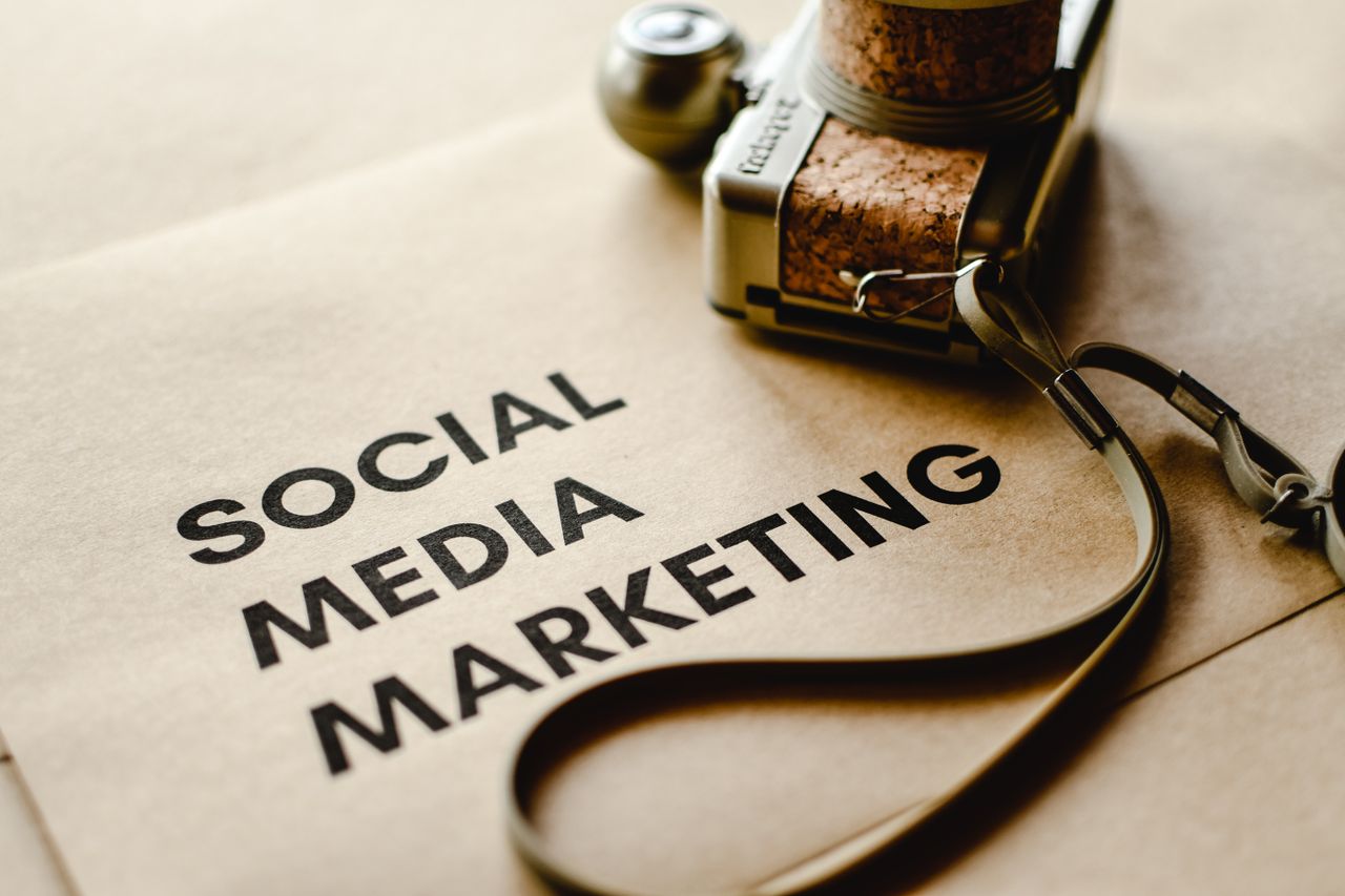 services-01 Close-up of a camera placed on brown paper with Social Media Marketing text, emphasizing digital marketing themes.